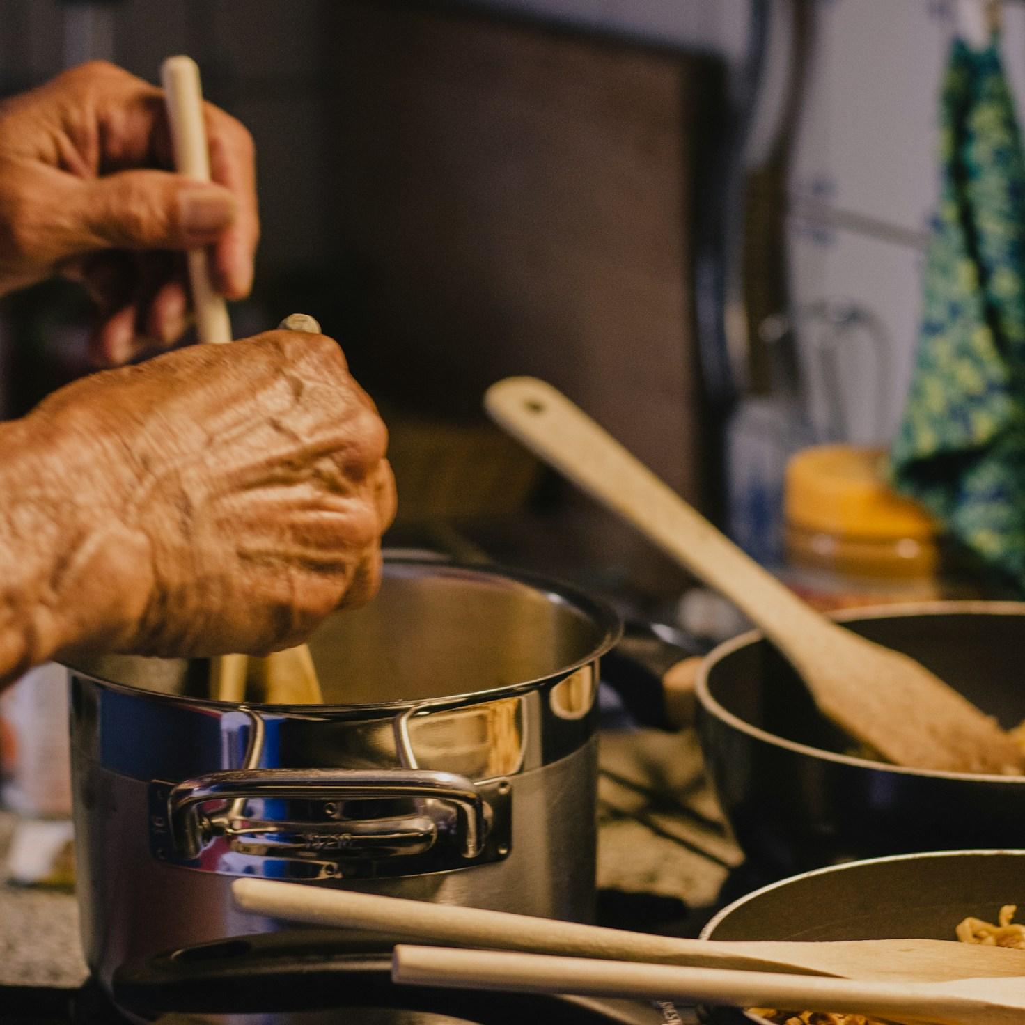 Community members collaborating in a modern kitchen space, sharing recipes and cooking techniques